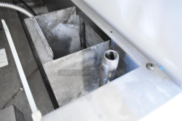Interior view of Garland Master 200 MCO-GS-10S convection oven, showing metal racks and gas components.