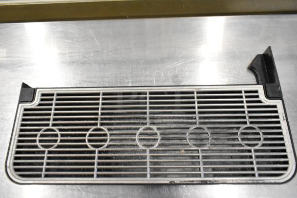 Metal grate component from United Food Group UV-PSPD-5-AV-BL-T-B Cappuccino Machine, showing wear.