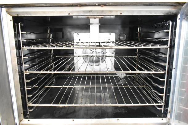 Vulcan VC4GD stainless steel convection oven interior with metal racks, view-through doors, thermostatic controls, on casters.