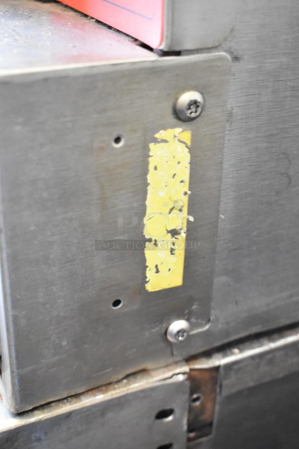 Vulcan VC4GD stainless steel convection oven detail, showing door with worn yellow marking and metal surface.