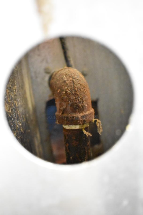 A close-up of a rusty pipe joint inside the Vulcan VC4GD convection oven, indicating wear and potential maintenance needs.