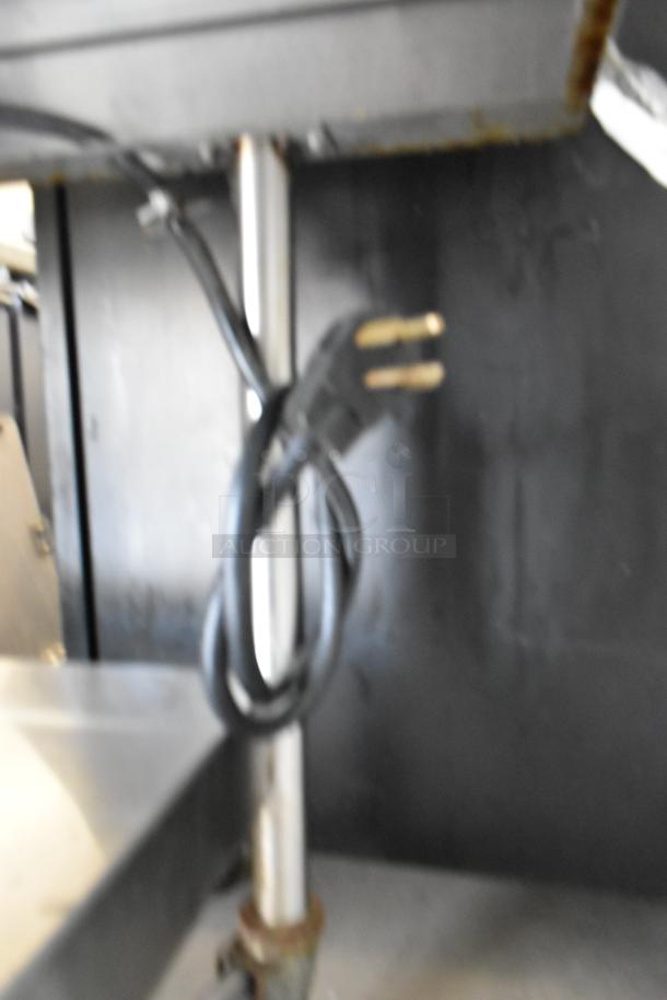 AccuTemp EGF2083A2450 stainless steel electric griddle with under shelf, on casters, 208V, 3-phase power plug visible.