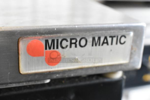 Micro Matic MDD-23 metal kegerator with logo, durable commercial design, 115 volts, 1 phase, on caster wheels, slight wear.
