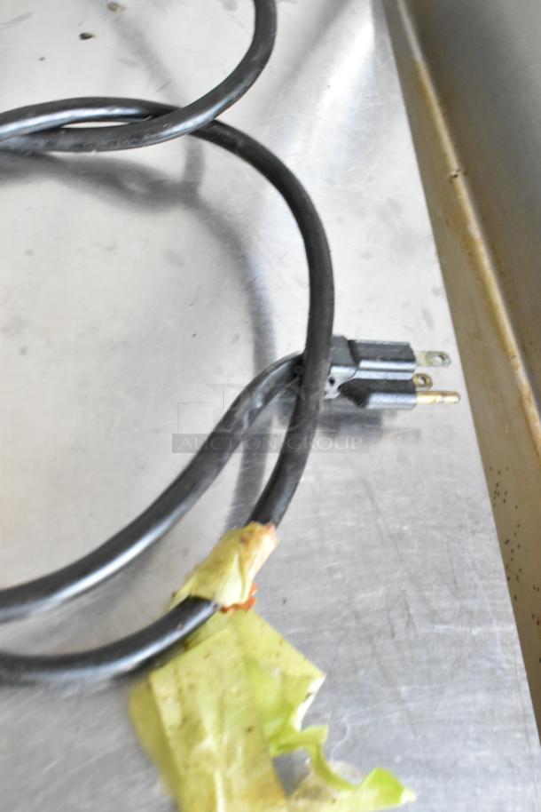 Micro Matic MDD-23 metal kegerator power cord on metal surface, 115 volts, 1 phase, commercial casters not visible.