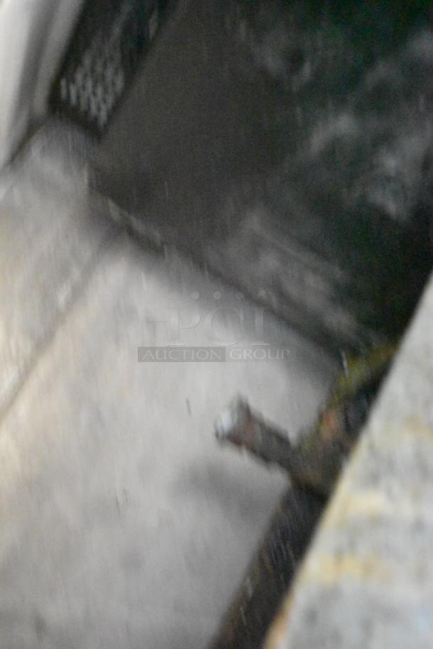 Blurry image, unable to identify the Avantco FF300-N Stainless Steel Commercial Natural Gas Deep Fat Fryer.