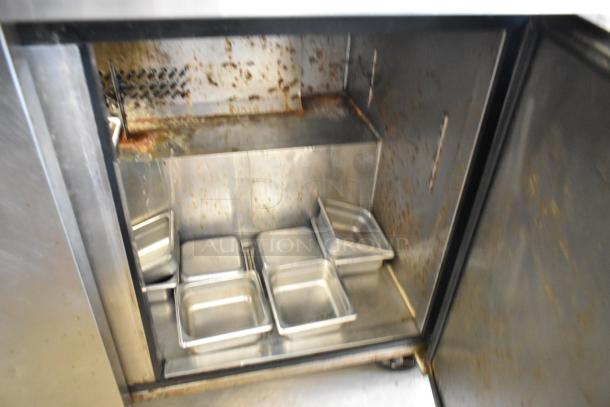 Bison MSF8308 stainless steel commercial prep table Bain Marie, visible rust and wear inside, includes several pans, on casters.