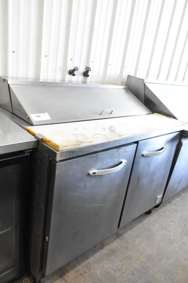 Ikon KSP48 stainless steel commercial sandwich salad prep table with bain marie mega top, visible wear, on casters.
