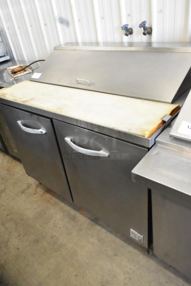 Ikon KSP48 stainless steel sandwich salad prep table, mega top, on casters. Features dual storage doors and a prep area.
