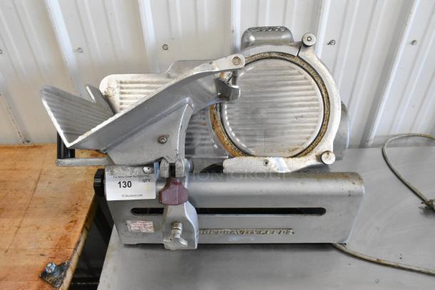 Globe 285 metal meat slicer with blade sharpener, countertop model. Visible wear, includes 115V, 1 Phase power label.