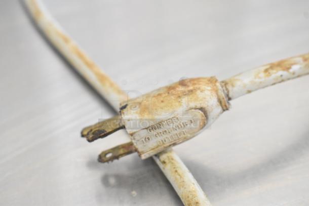 Close-up of a rusty power plug from the Globe 285 Metal Commercial Countertop Meat Slicer. Markings read "Connect to grounded outlet."