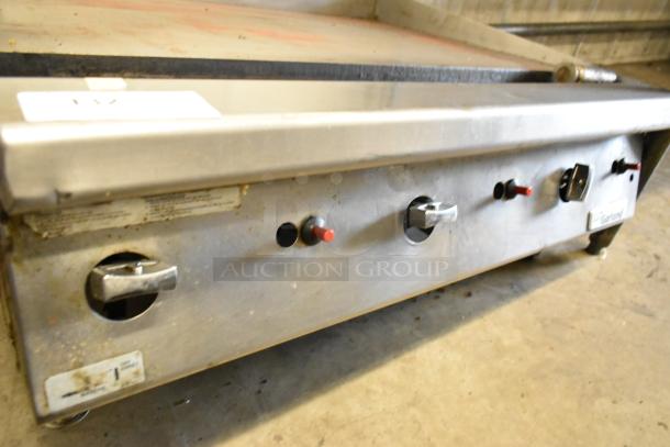 Garland stainless steel commercial countertop gas griddle, used, features adjustable knobs and Garland branding.