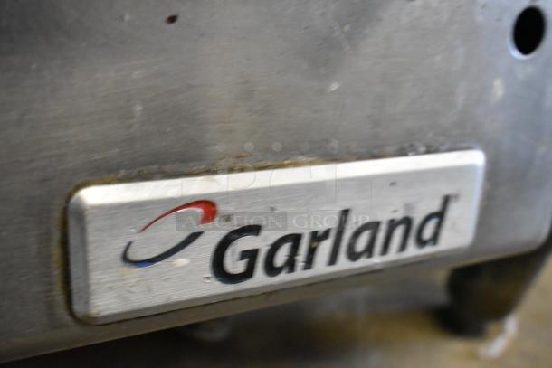 Garland stainless steel commercial gas griddle, countertop model, flat top, with visible logo plate, in used condition.