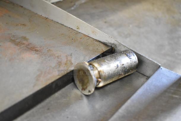 Garland Stainless Steel Commercial Countertop Gas Griddle, flat top, worn surface, durable construction.