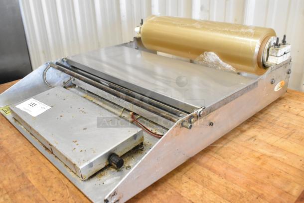 Avantco 177WM18 metal countertop roll film wrapping machine, 120V, 1 phase, used condition, visible wear on metal surface.