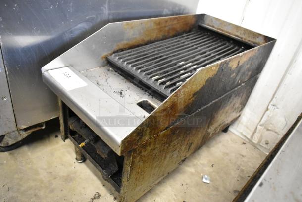 Metal commercial gas-powered charbroiler grill with visible wear. Includes label "134" indicating item number. Ideal for restaurant use.