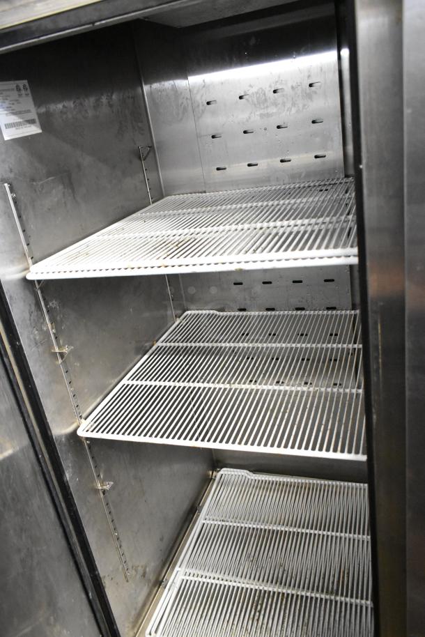 2020 Atosa MBF8503GR stainless steel commercial freezer interior with poly-coated racks and metal pan rack, on casters.