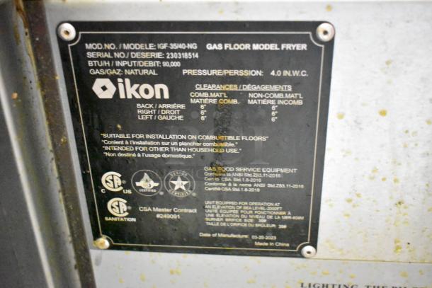 2023 Ikon IGF-35/40-NG stainless steel commercial gas fryer, 90,000 BTU, with label indicating model details and CSA certification.