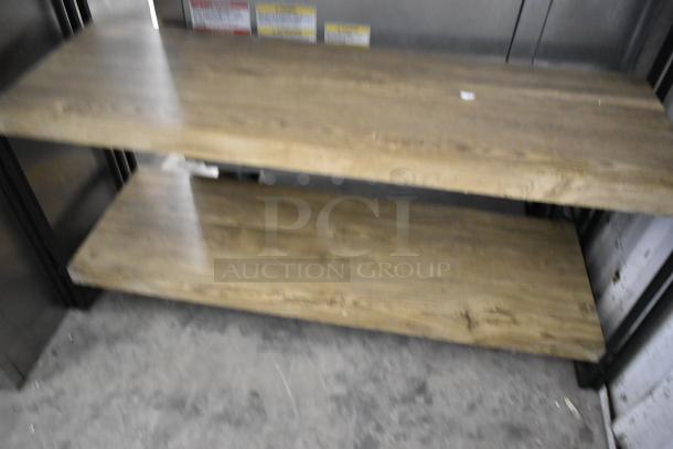 Wooden 4 tier shelving unit, features sturdy wood construction. Slight wear visible, ideal for storage or display.