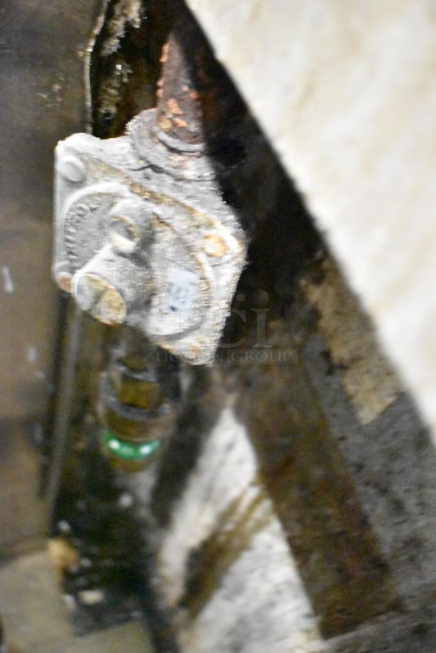 Jade Range gas connection detail. Shows rusted components, indicative of use and potential need for inspection.