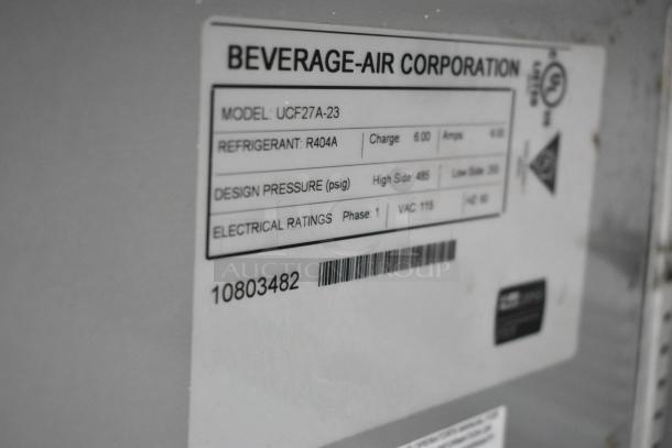 Beverage Air UCF27A-23 label showing model, refrigerant R404A, pressure ratings, and 115V electrical info.