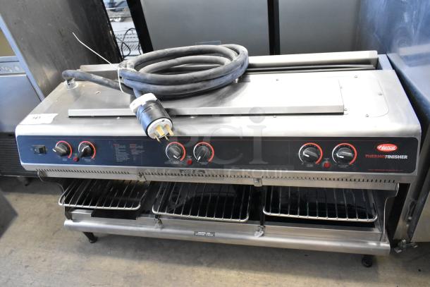 Hatco TFWM-3939 metal commercial wall-mounted Thermo-Finisher, 208 volts, 3 phase, featuring control knobs and dual shelves.
