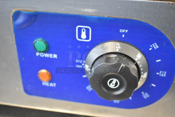 Stainless steel electric griddle control panel with power and heat indicators, temperature dial marked in Fahrenheit and Celsius.