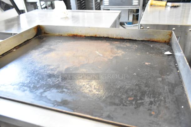 Stainless steel commercial countertop electric griddle, 110 volts, 1 phase, used condition with visible wear on the surface.