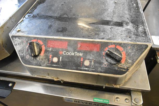 CookTek MC2502F 2 burner induction range with visible wear and dirt. Model details on front panel. 200-240V, 1 phase.