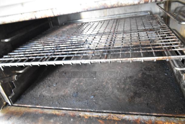 Jade Range J9R-6-36 stainless steel oven interior with grilling rack, showing signs of use, from a commercial 6-burner range.