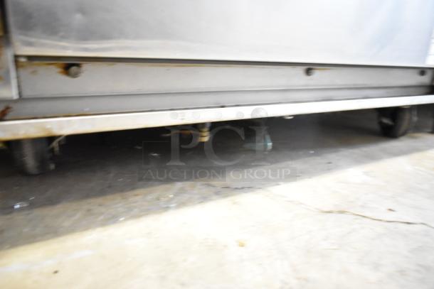 CresCor H137WSUA6D heated holding cabinet, stainless steel, on commercial casters, showing underside condition.