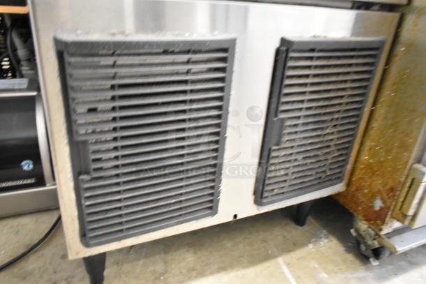 Hoshizaki F-330BAJ stainless steel ice machine, 115V, showing vents and moderate wear, ideal for commercial use.