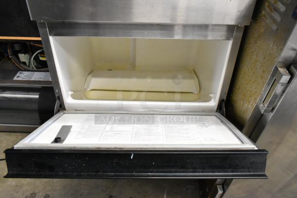 Hoshizaki F-330BAJ stainless steel ice machine. Self-contained, 115V, 1 Phase. Clean interior, visible instruction labels.