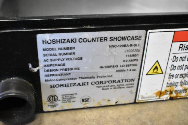 Hoshizaki HNC-120BA-R-SLH tag displaying model, serial number, voltage, and refrigerant details.