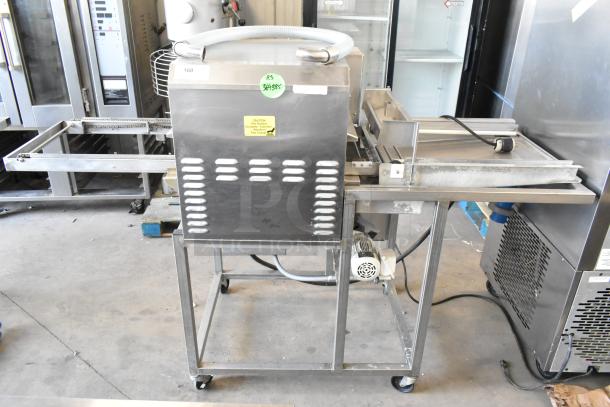 Belshaw TG50 stainless steel thermoglazing station with commercial casters, 208V, 1 phase. Visible caution label on front.