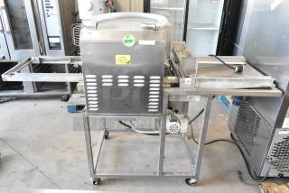 Belshaw TG50 stainless steel thermoglazing station with commercial casters, 208V, 1 phase. Visible caution label on front.