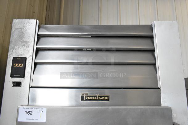 Traulsen G10010 stainless steel reach-in cooler; single door, poly coated racks, commercial casters, 115V, 1 phase.