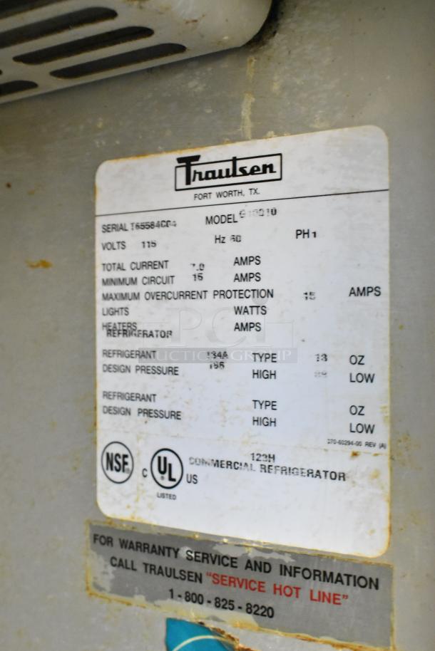 Traulsen G10010 commercial cooler label showing model, serial number, voltage, and UL certification.