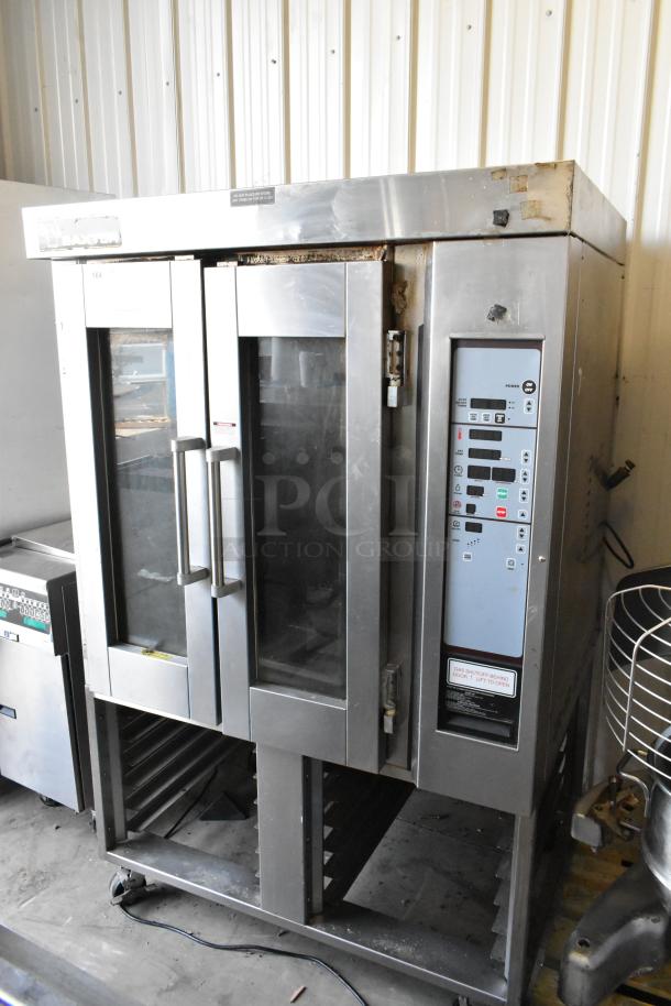 Baxter stainless steel natural gas mini rotating rack oven with double pan rack and commercial casters, used condition.