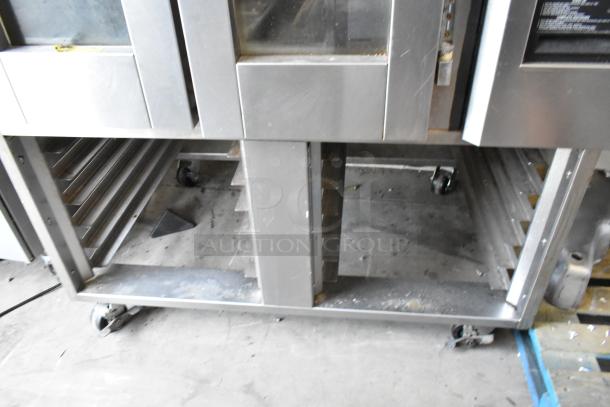 Baxter stainless steel commercial natural gas mini rotating rack oven with double pan rack and commercial casters.