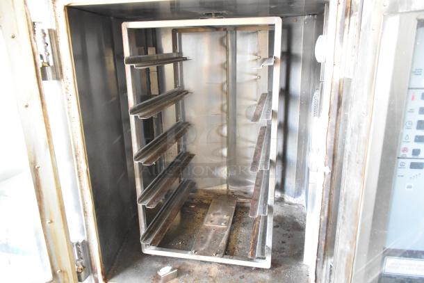 Baxter stainless steel rotating rack oven for sale, featuring a mini design, double pan rack, and commercial casters; used condition.