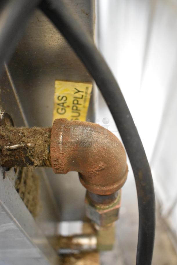 Baxter stainless steel commercial natural gas mini rotating rack oven, close-up of gas supply connection.