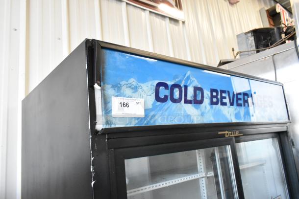 True GDM-41 metal commercial 2-door cooler with poly-coated racks on casters, 115V, 1 phase. "Cold Beverages" display.