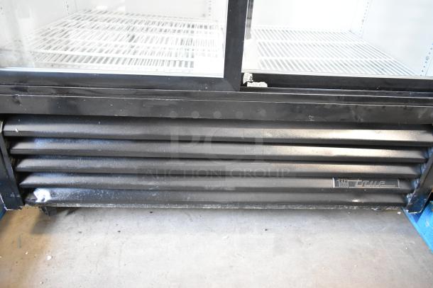 True GDM-41 two-door cooler merchandiser with metal frame, poly-coated racks, on commercial casters. 115 Volts, 1 Phase.