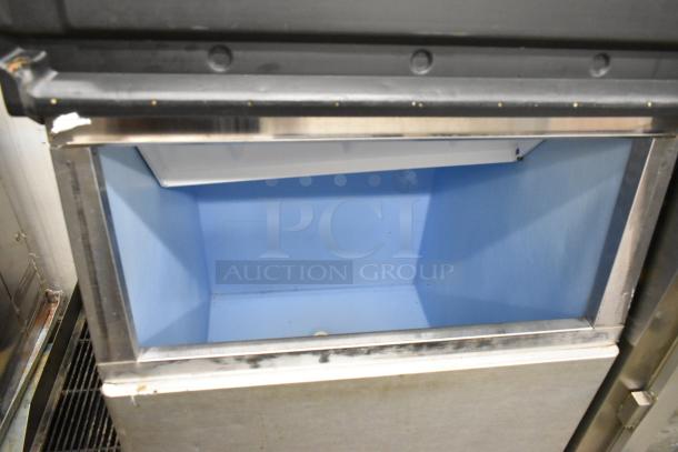 Hoshizaki KML-631MAH stainless steel commercial ice head on bin, 208-230V, 1 phase, open blue interior, slight wear visible.
