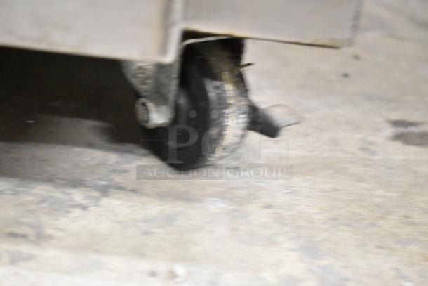 Super Systems OP-3 oven proofer caster detail, showing wear. Stainless steel body, commercial quality. 120/208V, 3 phase.