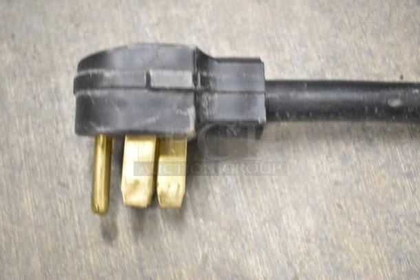 Close-up of an electric power plug for the Super Systems OP-3 commercial oven proofer, featuring brass prongs.