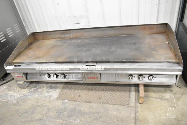 Lang Stainless Steel Commercial Countertop Flat Top Griddle in used condition with controls. Features Lang branding.