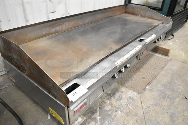 Lang Stainless Steel Commercial Countertop Flat Top Griddle, shows signs of use, multiple burner controls, and Lang branding.