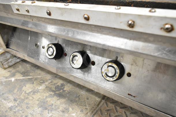 Lang Stainless Steel Commercial Countertop Flat Top Griddle with control knobs visible, showing used condition.