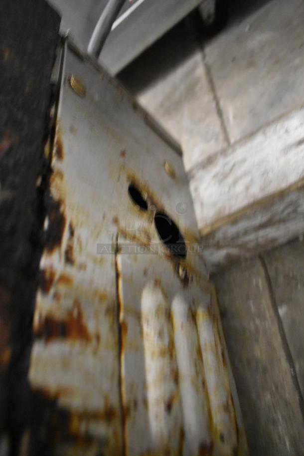 Lang Stainless Steel Commercial Countertop Flat Top Griddle, showing signs of rust and wear on the side panel.